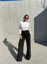 Crne trendy zvonaste pantalone visokog struka sa kosim džepovima