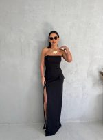 Uska duga crna top haljina sa dubokim šlicem sa strane i sa imitacijom džepova